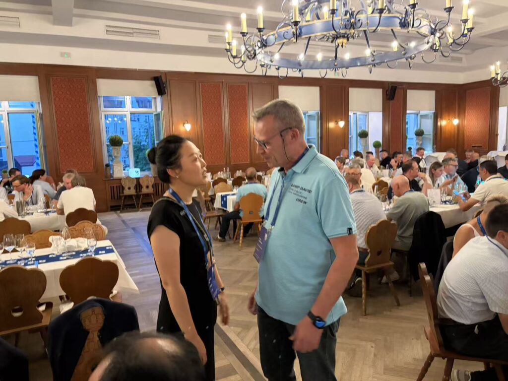 Woman and man conversing at a formal dinner event.