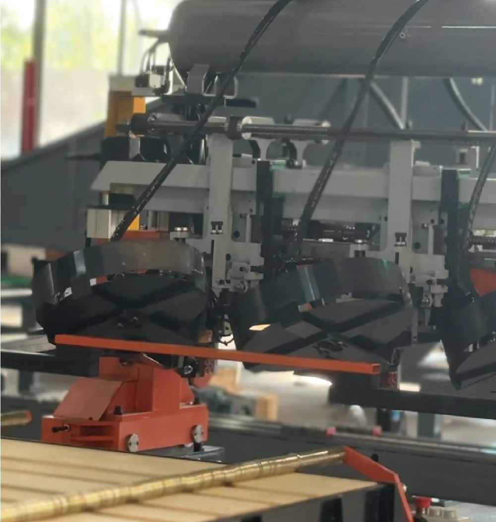 Industrial robotic machinery processing wooden boards in a factory.
